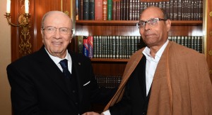 Tunisian newly-elected President Beji Caid Essebsi (L) shakes hands with his predecessor Moncef Marzouki during a handover ceremony on December 31, 2014 at the Carthage presidential Palace in Tunis. The election of Essebsi, a veteran of previous regimes, is seen as a landmark for the North African nation, where longtime dictator Zine El Abidine Ben Ali was toppled in 2011. AFP PHOTO / FETHI BELAID (Photo credit should read FETHI BELAID/AFP/Getty Images)