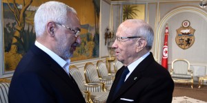Tunisian President Beji Ceid Essebsi (R) shakes hands with Ennahdha Islamist party Leader Rached Ghannouchi during an event in Tunis on January 14, 2015, marking the fourth anniversary of the ousting of Tunisia's longtime ruler Zine el Abidine Ben Ali, that sparked the Arab Spring uprisings. On January 14 2011, under massive popular pressure over unemployment and inflation, Ben Ali fled to Saudi Arabia with his family after 23 years in power. AFP PHOTO/ FETHI BELAID (Photo credit should read FETHI BELAID/AFP/Getty Images)