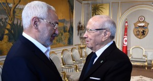 Tunisian President Beji Ceid Essebsi (R) shakes hands with Ennahdha Islamist party Leader Rached Ghannouchi during an event in Tunis on January 14, 2015, marking the fourth anniversary of the ousting of Tunisia's longtime ruler Zine el Abidine Ben Ali, that sparked the Arab Spring uprisings. On January 14 2011, under massive popular pressure over unemployment and inflation, Ben Ali fled to Saudi Arabia with his family after 23 years in power. AFP PHOTO/ FETHI BELAID        (Photo credit should read FETHI BELAID/AFP/Getty Images)